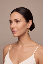 Pave U-link drop earring in gold worn on the ear
