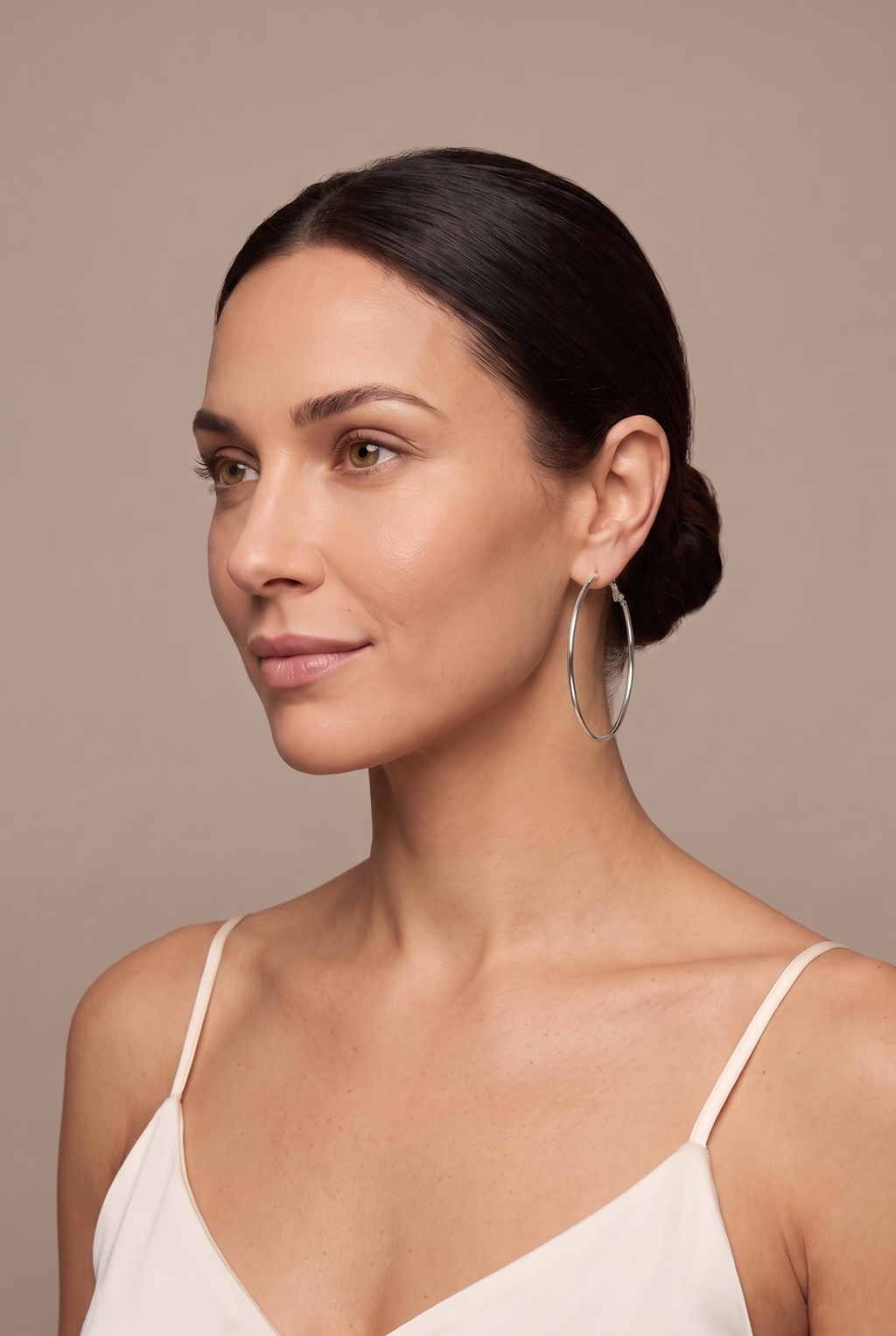 Large thin silver-tone hoop worn on the ear