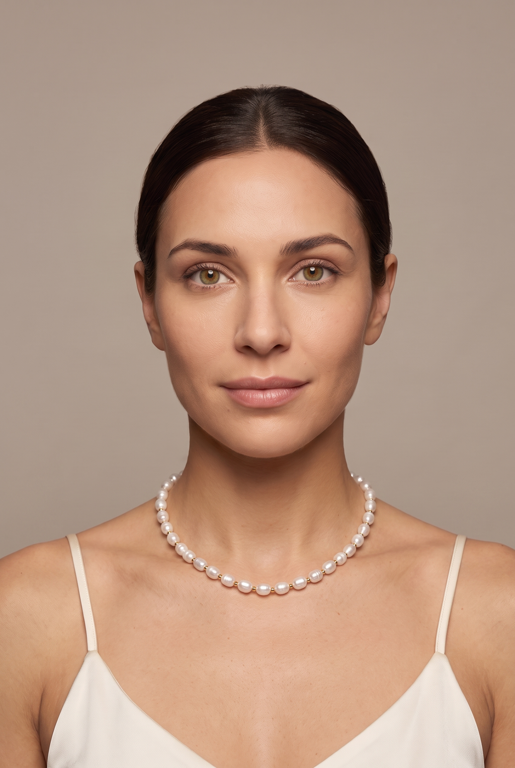 White rice pearl strand worn at the collarbone